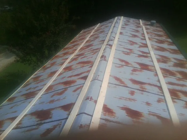 Rusted metal roof panels with new wood purlins before replacement — Storm Damage Roof Repair in Covina by Roofing Brothers
