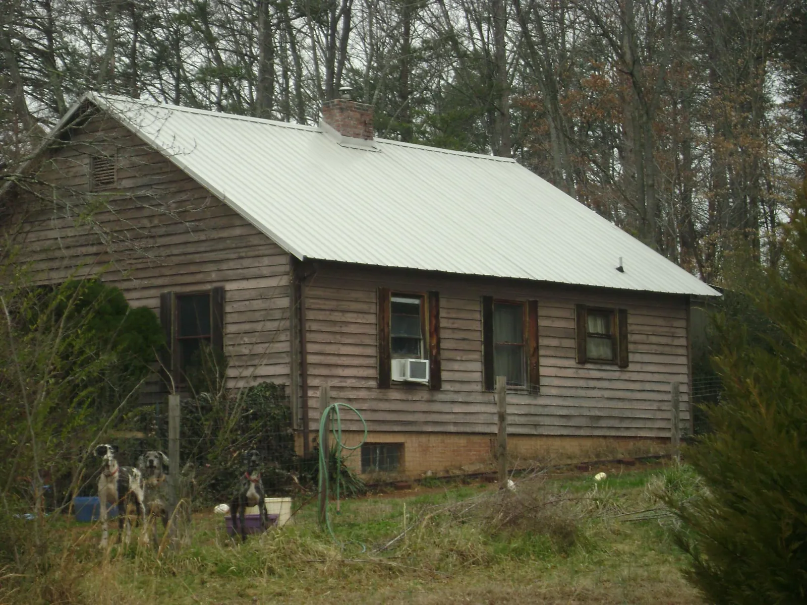 White metal roof on an old wood sided farmhouse, from a Metal Roof Installation job in Covina